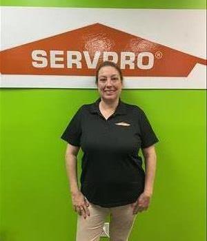 woman standing in front of door in SERVPRO shirt